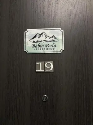 a wooden door with a sign on it at Babia Perła Zawoja in Zawoja