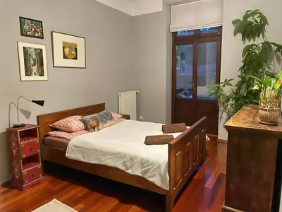 a bedroom with a bed and a plant in it at Dodo Acomodo 9 in Kraków