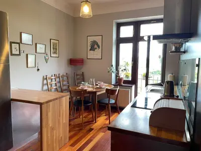 a kitchen and dining room with a table and chairs at Dodo Acomodo 9 in Kraków