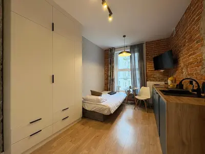 a bathroom with a white sink and a shower at Comfort Cube - Design Apartaments in Kraków
