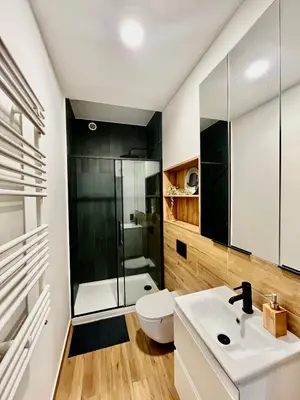 a kitchen with a couch and a brick wall at Comfort Cube - Design Apartaments in Kraków