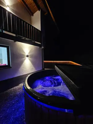 a hot tub in a room with blue lighting at Chata Pod Skarpą in Wieprzec