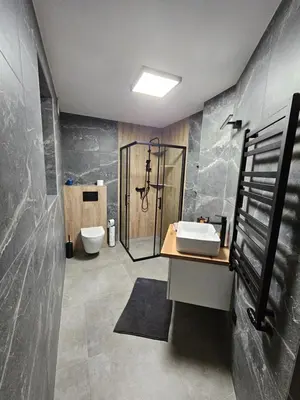 a bathroom with a shower and a sink and a toilet at Chata Pod Skarpą in Wieprzec