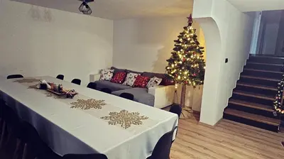 a living room with a christmas tree and a couch at Chata Pod Skarpą in Wieprzec