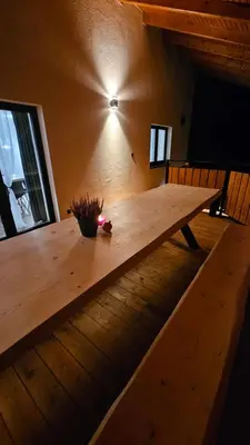 a wooden table in the middle of a room at Chata Pod Skarpą in Wieprzec