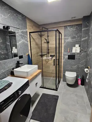 a bathroom with a shower and a sink and a toilet at Chata Pod Skarpą in Wieprzec