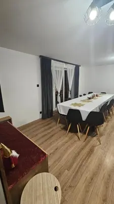 a room with a large white table and chairs at Chata Pod Skarpą in Wieprzec