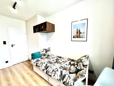 a bedroom with a bed and a couch at Cozy Loft - Design Apartaments in Kraków
