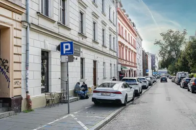 a parking lot with cars parked on a city street at Cracow Old Town Apartment by BookingHost in Kraków