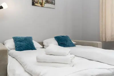 a couch with towels sitting on top of it at Cracow Old Town Apartment by BookingHost in Kraków