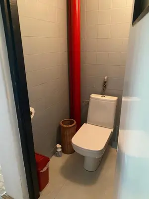 a bathroom with a white toilet in a stall at A BEAUTIFUL HOUSE near AIRPORT KRAKOW-BALICE