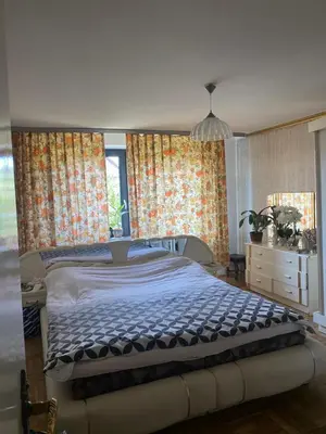 a bedroom with a bed and a dresser and windows at A BEAUTIFUL HOUSE near AIRPORT KRAKOW-BALICE