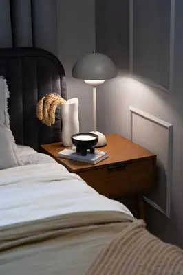 a bedroom with a bed and a table with a lamp at Noble Apartment in Kraków