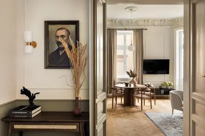 a living room with a portrait of a man on the wall at Noble Apartment in Kraków