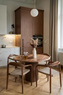 a dining room table with two chairs and a vase on it at Noble Apartment in Kraków