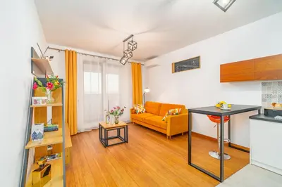 a living room with a couch and a table at Krakow Studio Air Con 10th Floor Balcony in Kraków