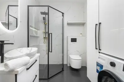 a bathroom with a glass shower and a toilet at Grzegórzecka 69E Kraków Bright Apartment Near Centre in Kraków