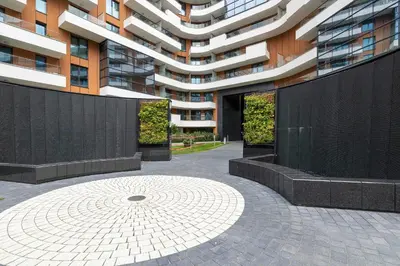 a large apartment building with a courtyard in front of it at Grzegórzecka 69E Kraków Bright Apartment Near Centre in Kraków