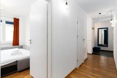a television on a white stand with a remote control at Sewera Cozy Nest Apartment by BookingHost in Kraków