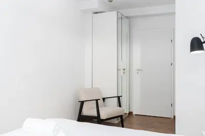 a bedroom with a bed and a desk and a computer at Sewera Cozy Nest Apartment by BookingHost in Kraków