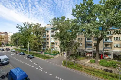a view of a street with cars parked on the road at Kazimierza Wielkiego 2-Bedroom Apartment with Parking by Noclegi Renters in Kraków