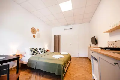 a bedroom with a bed and a couch in a room at Airport Lux Balice in Szczyglice