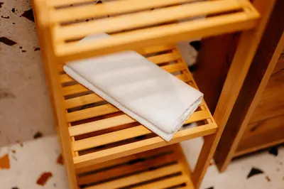 a wooden stool with a white towel on it at Airport Lux Balice in Szczyglice