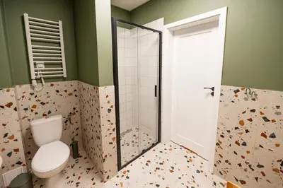 a bathroom with a toilet and a shower at Airport Lux Balice in Szczyglice