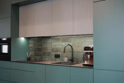 a kitchen with white cabinets and a sink and a microwave at Smoleńsk 33 Luxury Apartment in Kraków