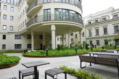 a building with benches and tables in front of it at Smoleńsk 33 Luxury Apartment in Kraków