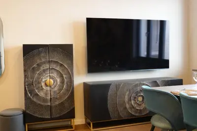 a room with a tv and a fan and a table at Smoleńsk 33 Luxury Apartment in Kraków