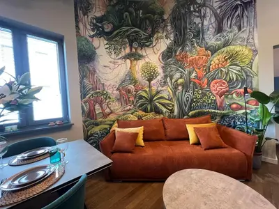 a living room with a couch and a colorful wall at Smoleńsk 33 Luxury Apartment in Kraków