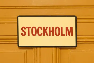 a sign on a wooden door with the word stokhalim on it at WOW Hostel in Kraków