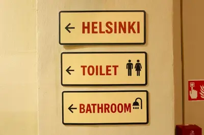 a group of signs on a wall at WOW Hostel in Kraków