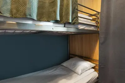 a bunk bed in a small room with a bunk bedutenewayangering at WOW Hostel in Kraków