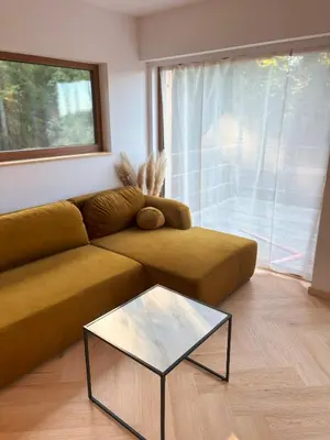 a living room with a couch and a glass table at Apartament pod lasem 2 - przy szlaku na Turbacz, w pobliżu wyciągów narciarskich in Nowy Targ
