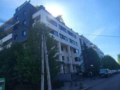 a tall white building on the side of a street at Apartament Lea in Kraków