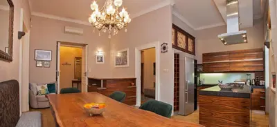 a dining room with a table and a kitchen at Large Apartment near Castle and Main Square in Kraków