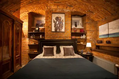 a bedroom with a bed in a brick wall at Large Apartment near Castle and Main Square in Kraków