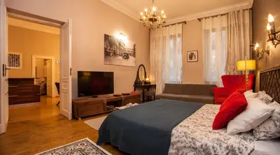 a bedroom with a bed and a tv and a couch at Large Apartment near Castle and Main Square in Kraków