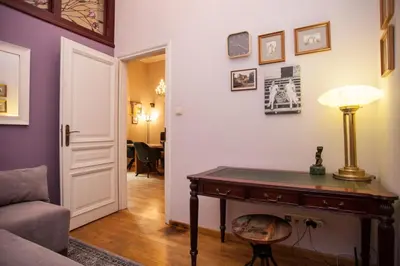 a living room with a table and a lamp at Large Apartment near Castle and Main Square in Kraków