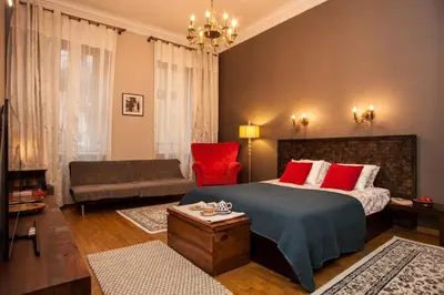a bedroom with a bed and a living room at Large Apartment near Castle and Main Square in Kraków