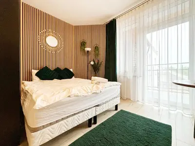 a bedroom with a bed and a large window at Batorego loft - 5 minutes to Main Square in Kraków