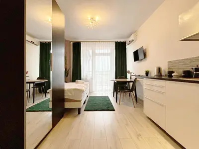 a room with a kitchen and a living room at Batorego loft - 5 minutes to Main Square in Kraków