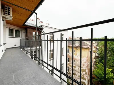 a balcony with a black railing and some buildings at Batorego loft - 5 minutes to Main Square in Kraków