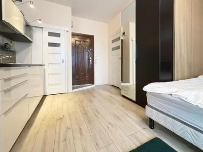 a bedroom with a bed and a wooden floor at Batorego loft - 5 minutes to Main Square in Kraków