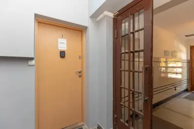 a hallway with a wooden door and a glass door at One-Bedroom Kazimierz Apartment for Home Office Starowiślna by Noclegi Renters in Kraków