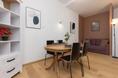 a dining room with a table and chairs at One-Bedroom Kazimierz Apartment for Home Office Starowiślna by Noclegi Renters in Kraków