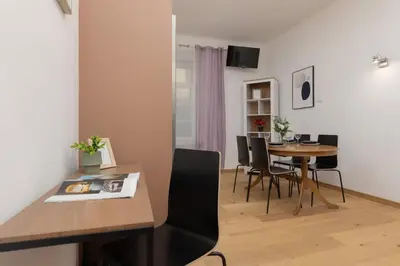 a dining room with a table and chairs at One-Bedroom Kazimierz Apartment for Home Office Starowiślna by Noclegi Renters in Kraków