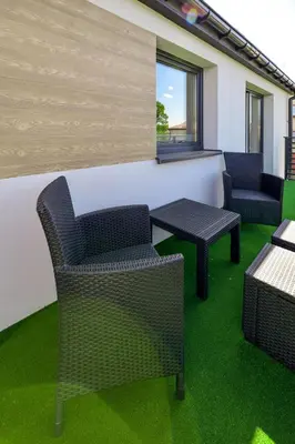 a room with chairs and tables on green grass at Sun & Garden View in Oświęcim